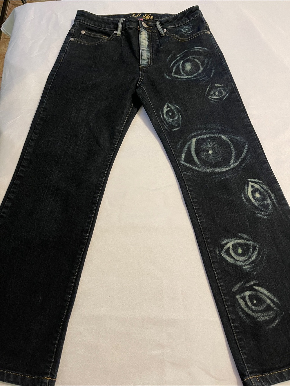 bill blass Black Denim Jeans with Faded Teal-White Eye Motif